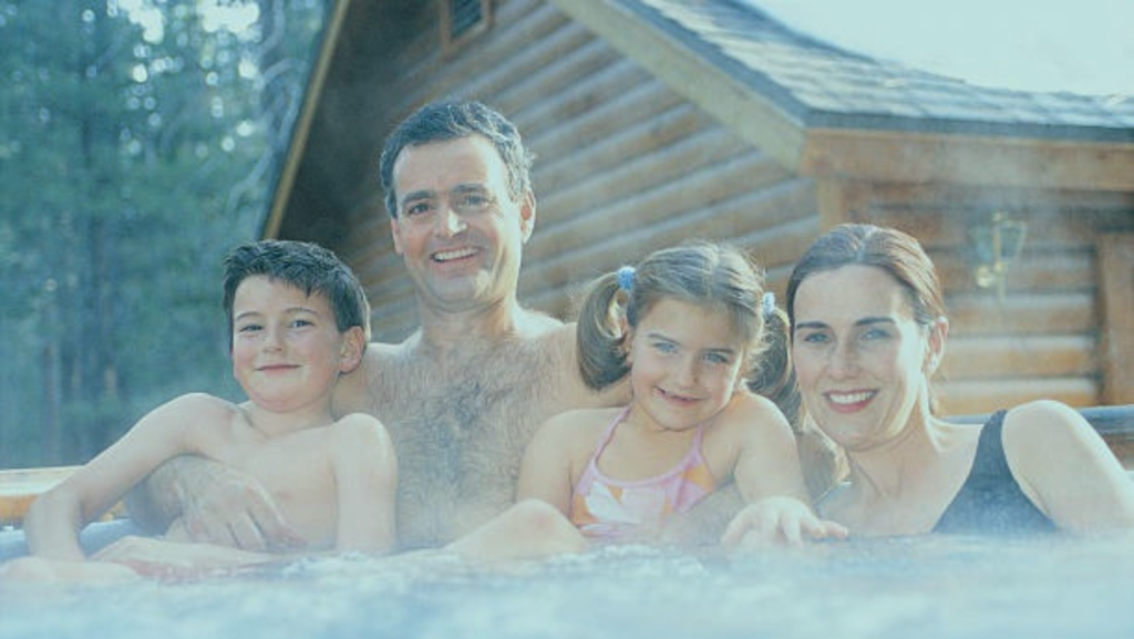 family enjoying the hot tub