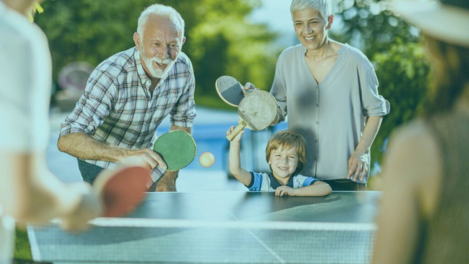 a family playing Ping Pong on family loving vacation rental of Bennington Properties